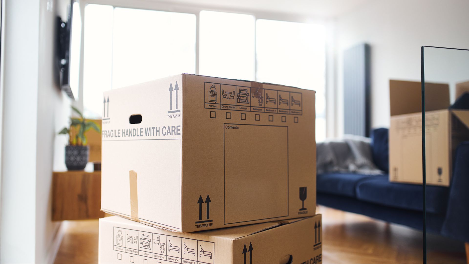 A stack of boxes sitting on top of a hard wood floor