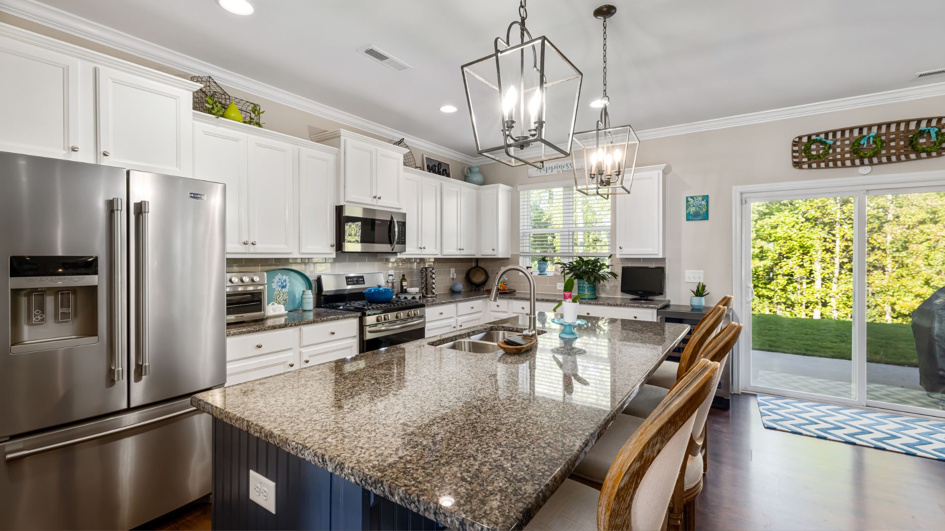 A kitchen with a large center island and stainless steel appliances